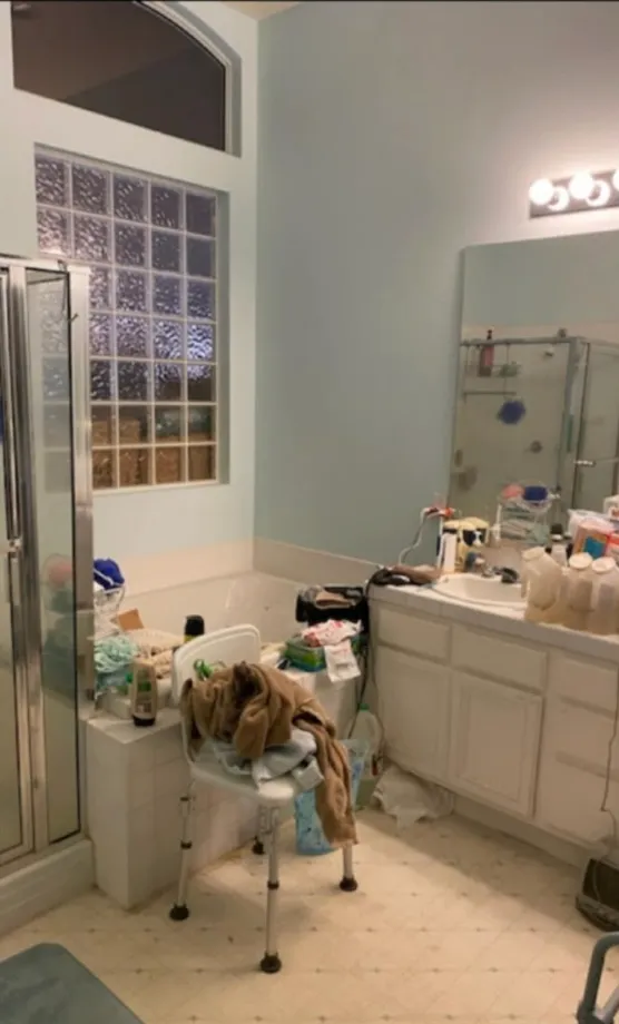 Cluttered bathroom with items on counter before cleaning.